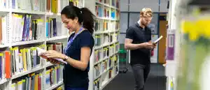 students looking for books in the perry library.